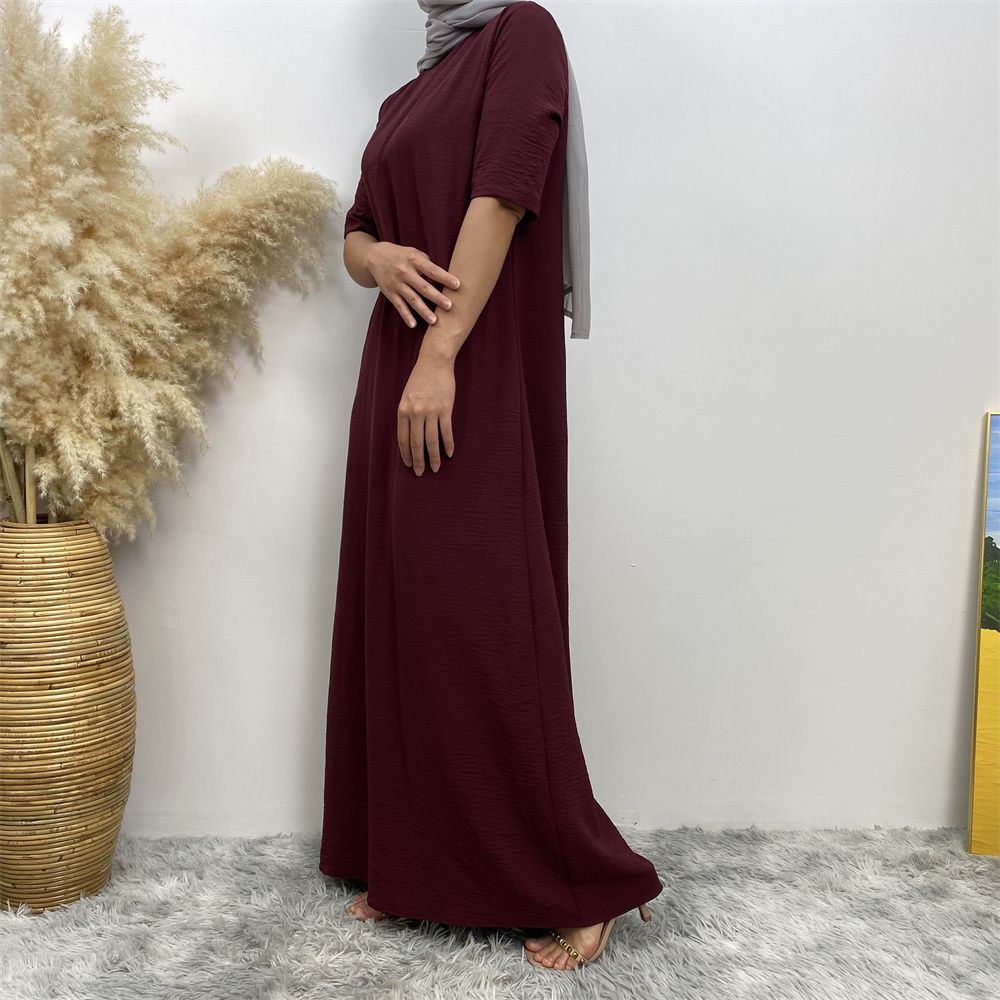 Muslim fashion: A simple, plain-colored mid-sleeved dress in Dubai, Middle East, and elegant women's clothing from Africa, Arabia and Turkey