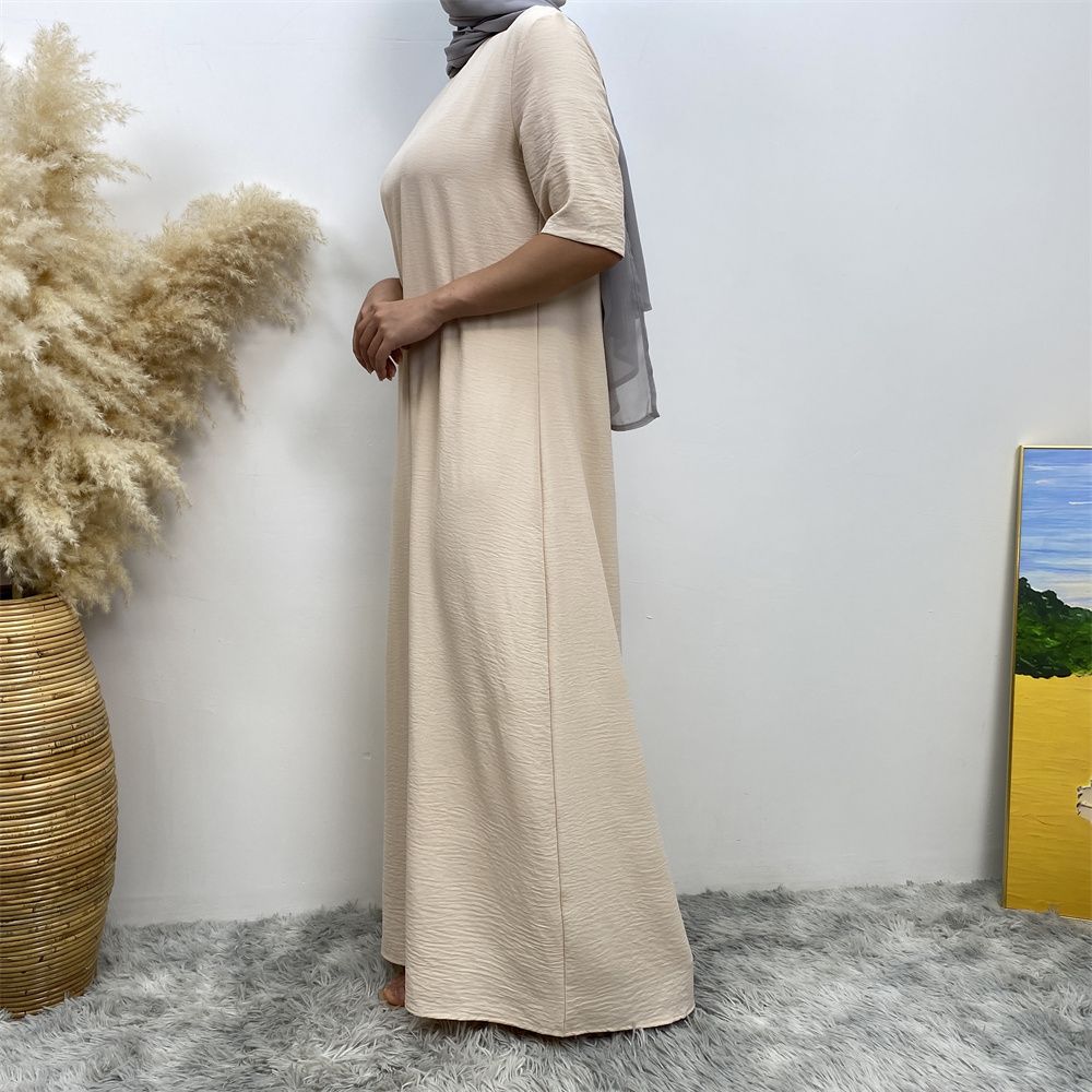 Muslim fashion: A simple, plain-colored mid-sleeved dress in Dubai, Middle East, and elegant women's clothing from Africa, Arabia and Turkey