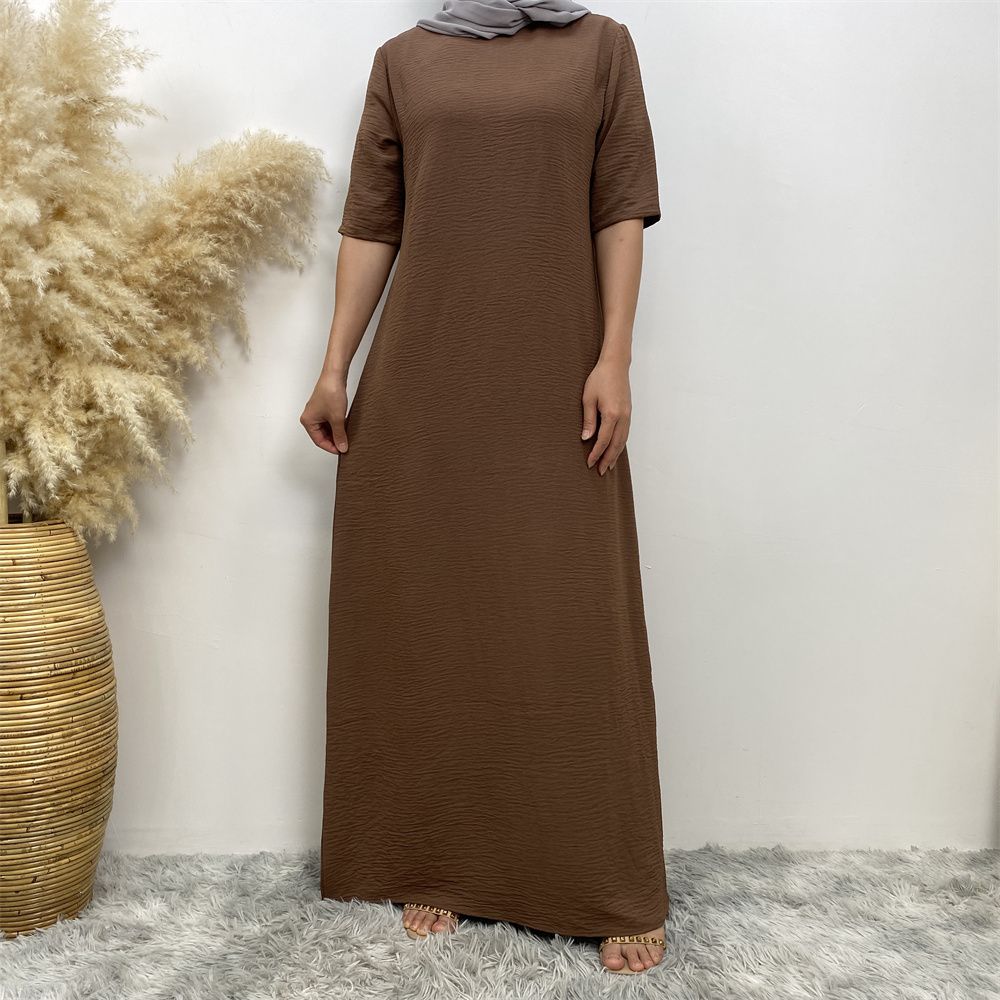 Muslim fashion: A simple, plain-colored mid-sleeved dress in Dubai, Middle East, and elegant women's clothing from Africa, Arabia and Turkey