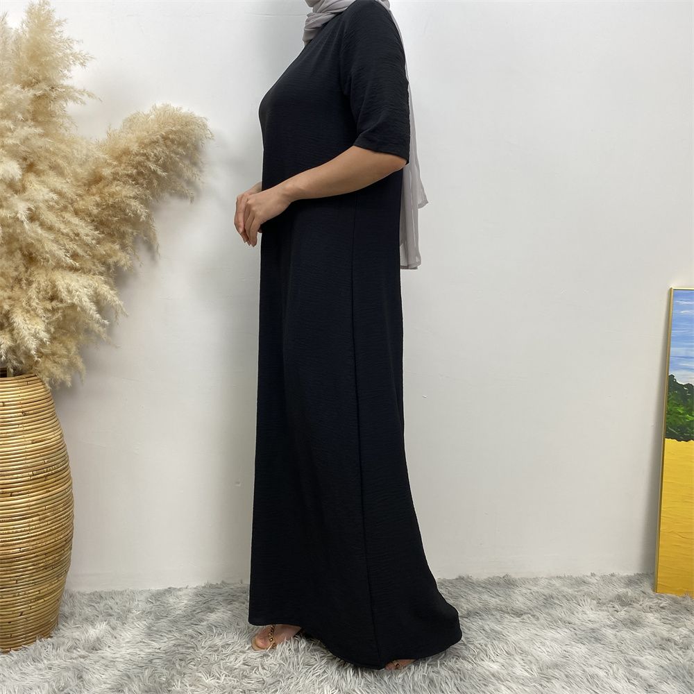 Muslim fashion: A simple, plain-colored mid-sleeved dress in Dubai, Middle East, and elegant women's clothing from Africa, Arabia and Turkey