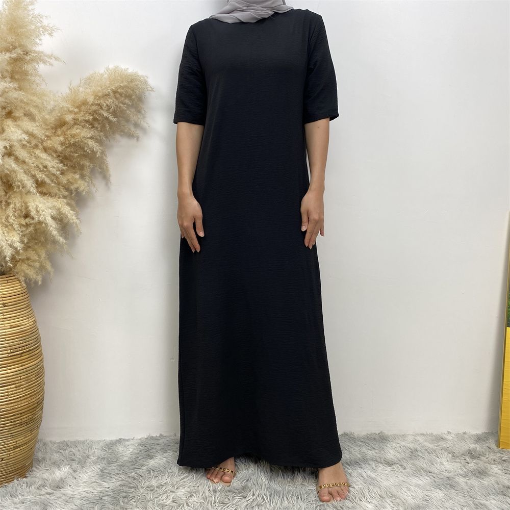 Muslim fashion: A simple, plain-colored mid-sleeved dress in Dubai, Middle East, and elegant women's clothing from Africa, Arabia and Turkey