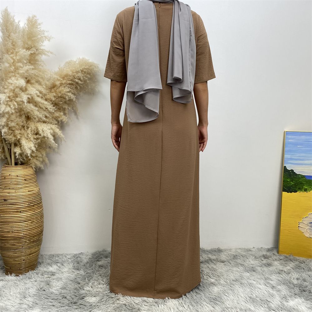Muslim fashion: A simple, plain-colored mid-sleeved dress in Dubai, Middle East, and elegant women's clothing from Africa, Arabia and Turkey