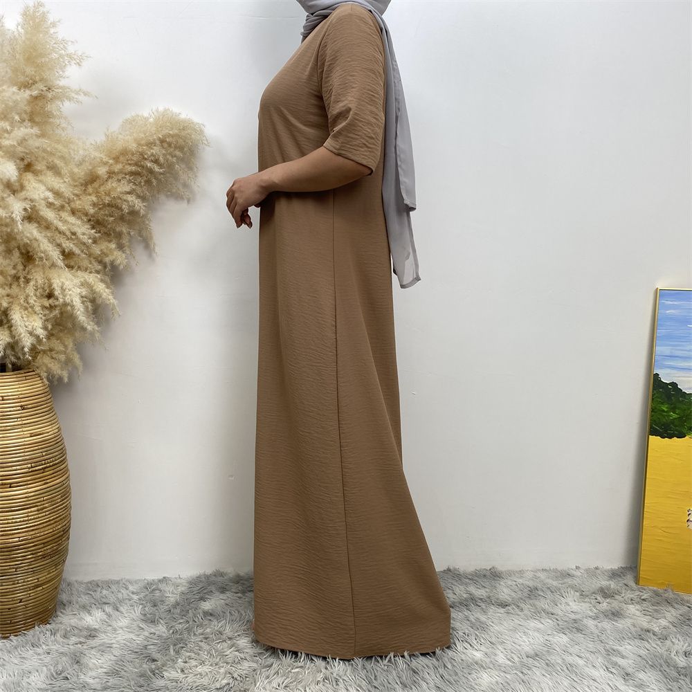 Muslim fashion: A simple, plain-colored mid-sleeved dress in Dubai, Middle East, and elegant women's clothing from Africa, Arabia and Turkey