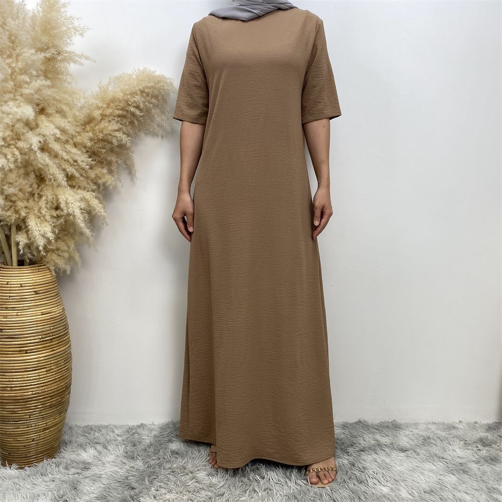Muslim fashion: A simple, plain-colored mid-sleeved dress in Dubai, Middle East, and elegant women's clothing from Africa, Arabia and Turkey