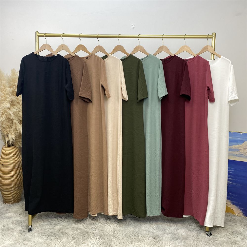Muslim fashion: A simple, plain-colored mid-sleeved dress in Dubai, Middle East, and elegant women's clothing from Africa, Arabia and Turkey