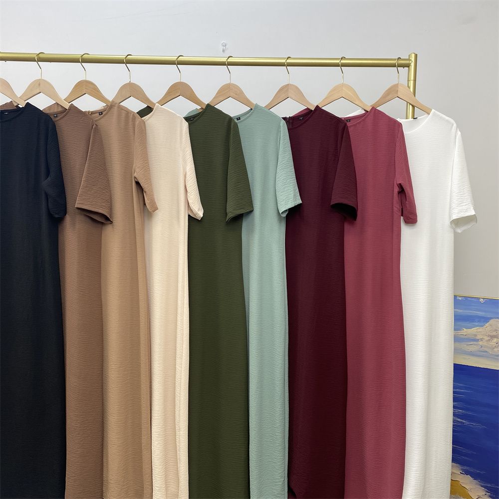 Muslim fashion: A simple, plain-colored mid-sleeved dress in Dubai, Middle East, and elegant women's clothing from Africa, Arabia and Turkey