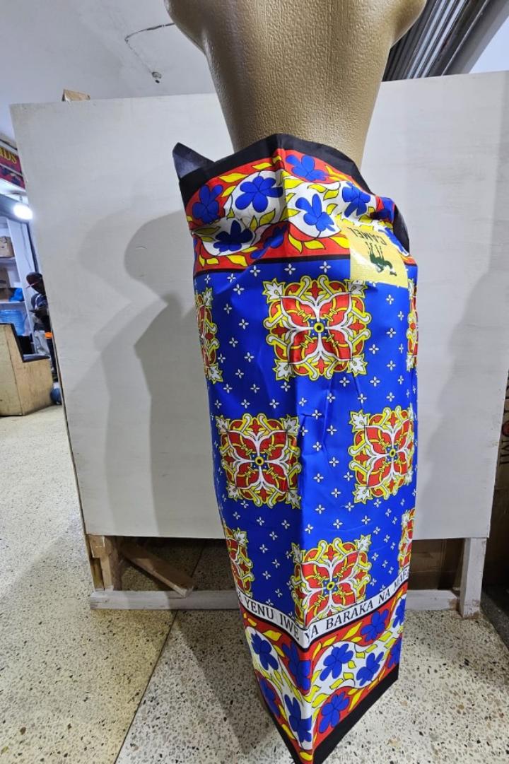 Vibrant LS03 Cotton Kitenge – Premium quality 100% cotton African fabric with bold blue, red, and yellow floral patterns. Perfect for dresses, skirts, shirts, and crafts. Soft, durable, and eye-catchi