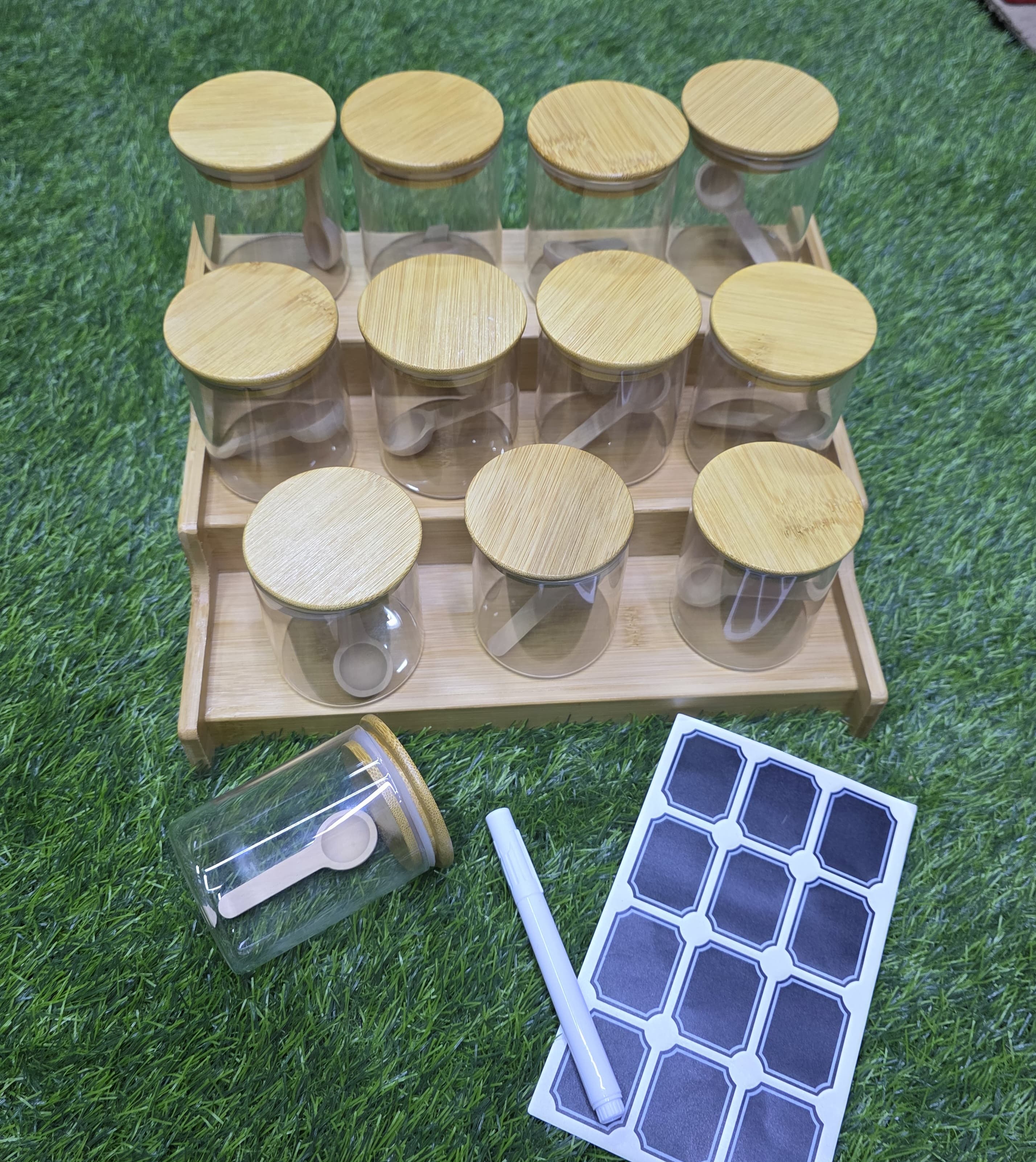 SPICE HOLDERS 12 PIECES WITH BAMBOO STAND 200ML HIGH QUALITY GLASS SPICE JAR SET. MATERIAL GLASS JAR+ BAMBOO LID COME WITH STICKERS PEN + CAPACITY: 200ML ▪AIRTIGHT