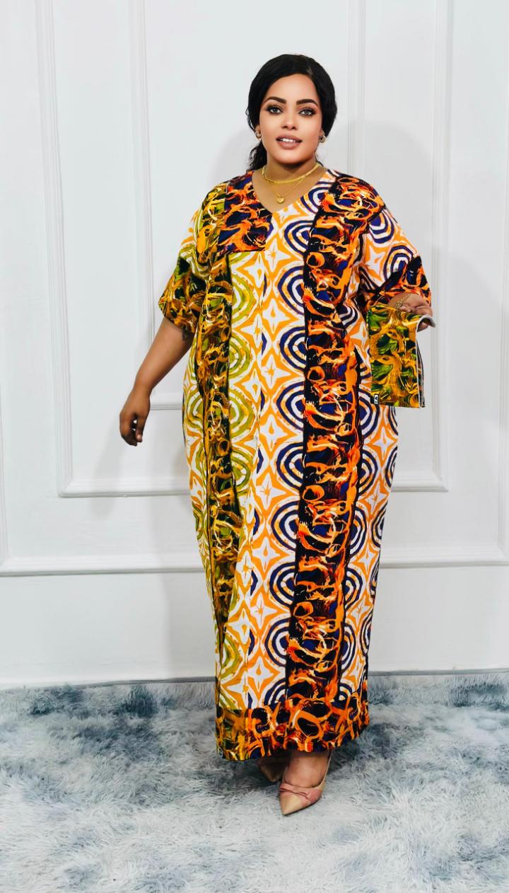 An elegant kitenge dress is a stylish and sophisticated garment made from vibrant African wax print fabric (kitenge), often tailored with modern or traditional designs. It typically features intricate