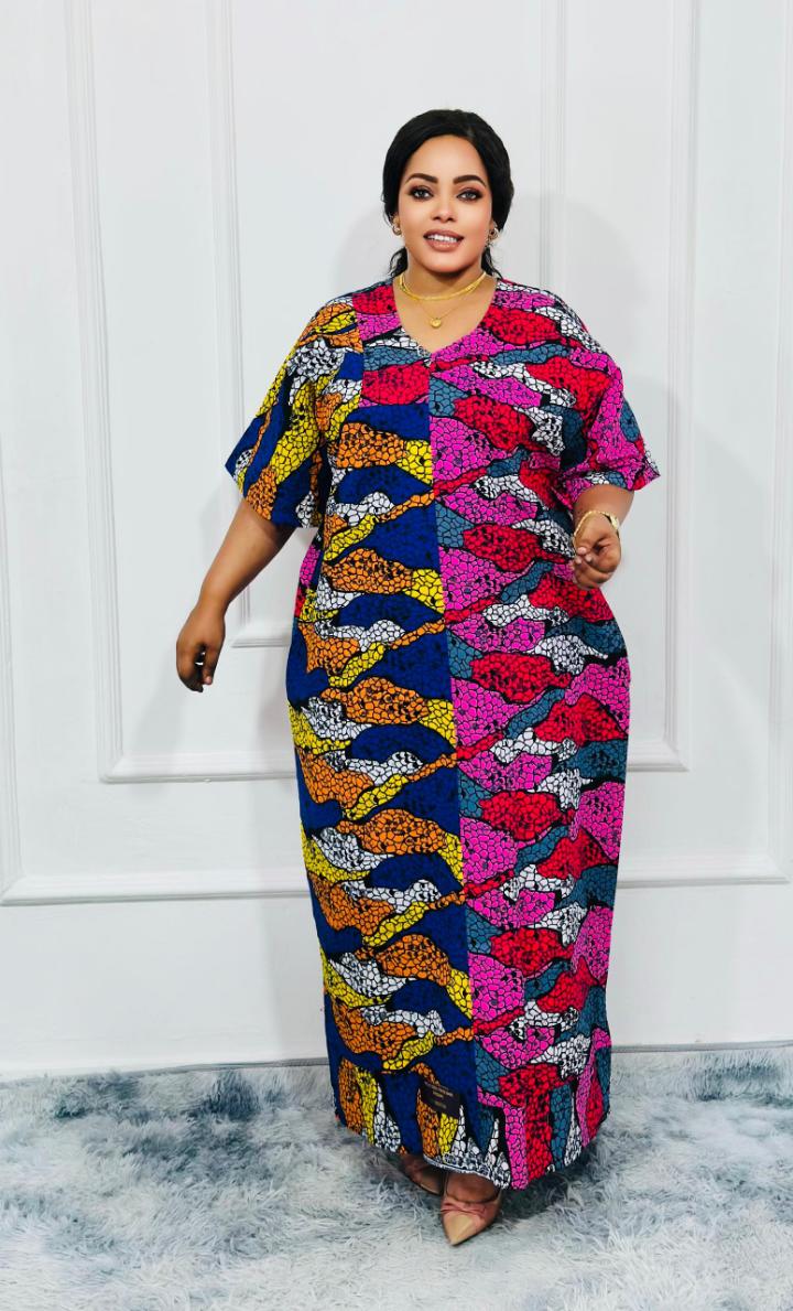 An elegant kitenge dress is a stylish and sophisticated garment made from vibrant African wax print fabric (kitenge), often tailored with modern or traditional designs. It typically features intricate