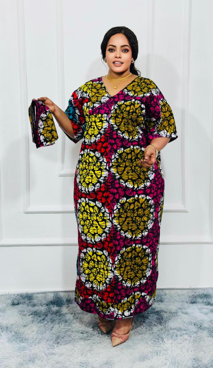 An elegant kitenge dress is a stylish and sophisticated garment made from vibrant African wax print fabric (kitenge), often tailored with modern or traditional designs. It typically features intricate