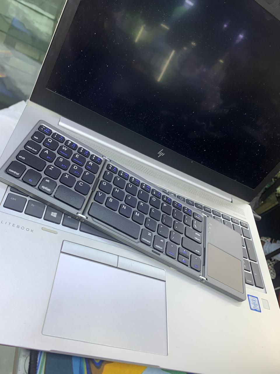 COMPACT FOLD-ABLE KEYBOARD RECHARGEABLE WITH TRACK-PAD USABLE WITH SMART DEVICES