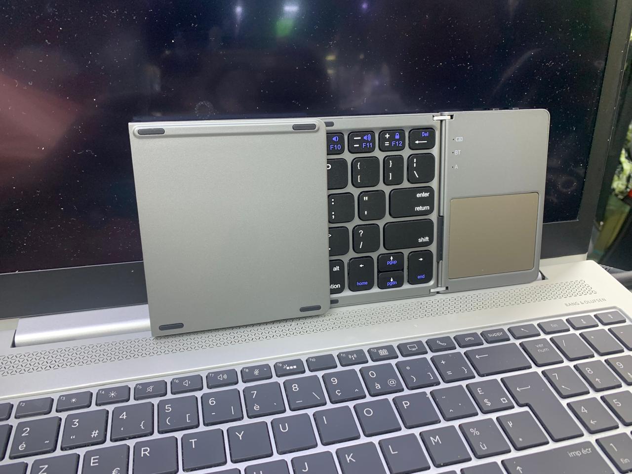 COMPACT FOLD-ABLE KEYBOARD RECHARGEABLE WITH TRACK-PAD USABLE WITH SMART DEVICES