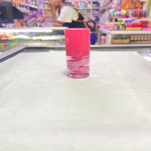 Kiss Beauty Fruit Lip Oil with a stunning pink tint. Indulge your lips. Experience nourishing hydration and a beautiful, vibrant finish that enhances your natural beauty! view 4