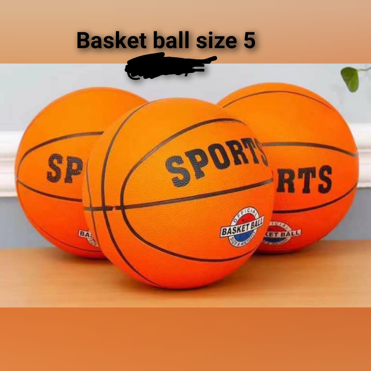 basketball, specifically a size 5 basketball, as indicated by the text "Basket ball size 5" on the image. The image shows three orange basketballs, with one prominently displaying the word "SPORTS" an