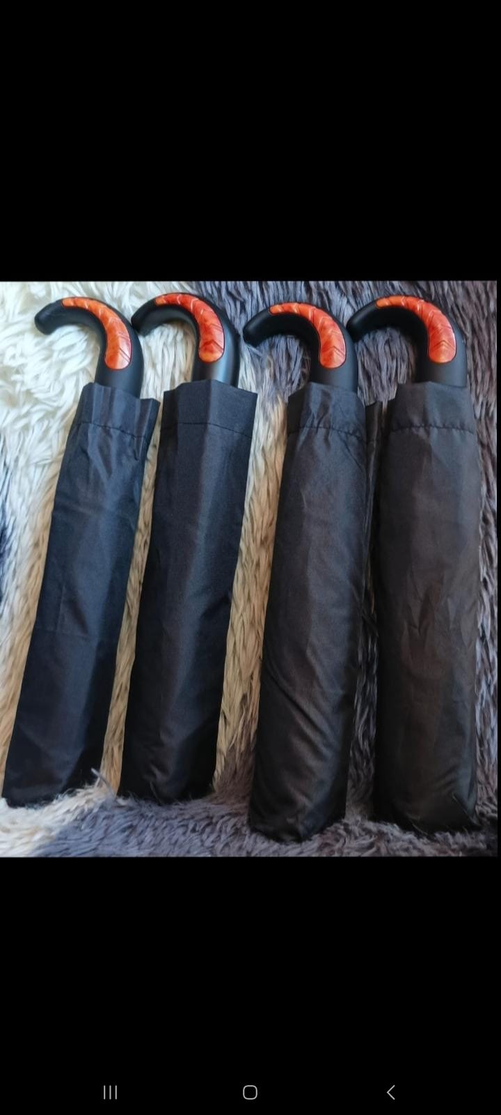 Strong Good Quality generic black foldable umbrella featuring curved handles and one-touch opening switches.