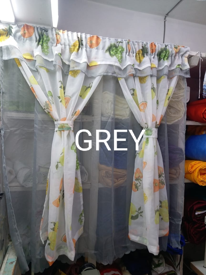 kitchen curtain. It appears to be a sheer curtain with a pineapple pattern. The curtain is tied back to let in light.