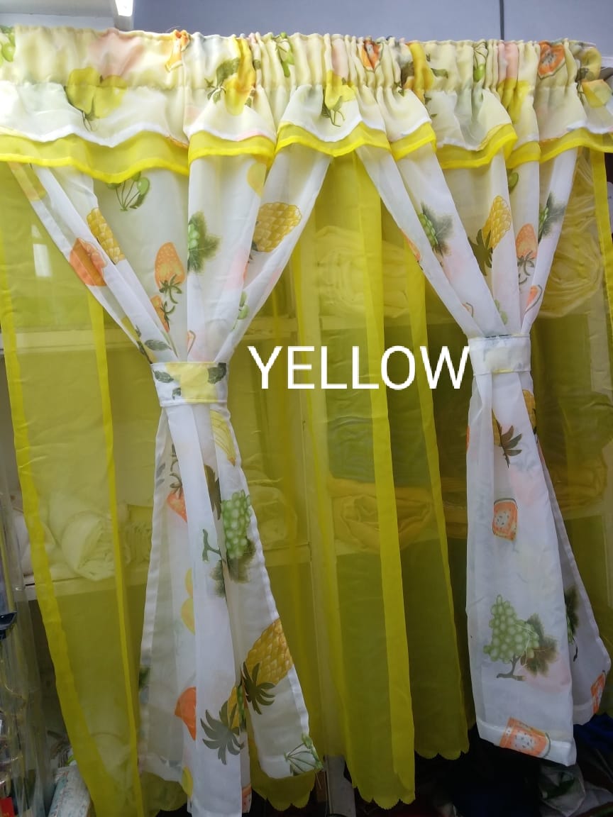 kitchen curtain. It appears to be a sheer curtain with a pineapple pattern. The curtain is tied back to let in light.