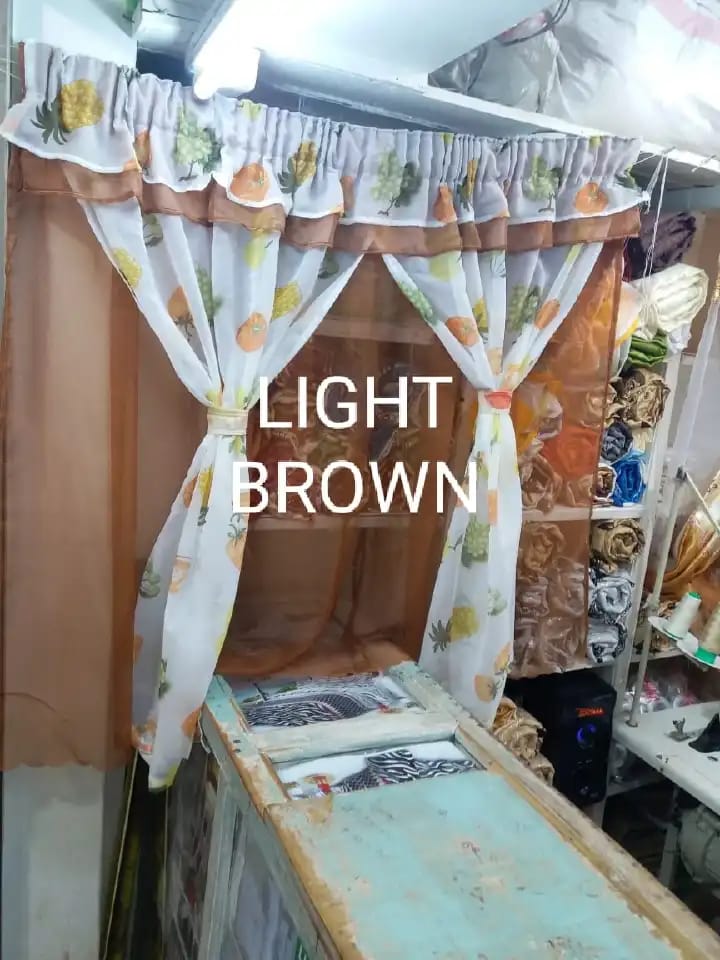 kitchen curtain. It appears to be a sheer curtain with a pineapple pattern. The curtain is tied back to let in light.