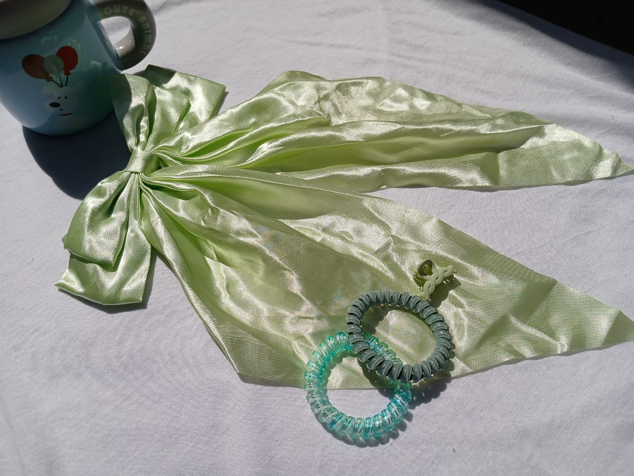 Stay fresh and stylish with this 4-in-1 Mint Green Hair Accessory Set – Satin Bow, Spiral Hair Ties & Claw Clip