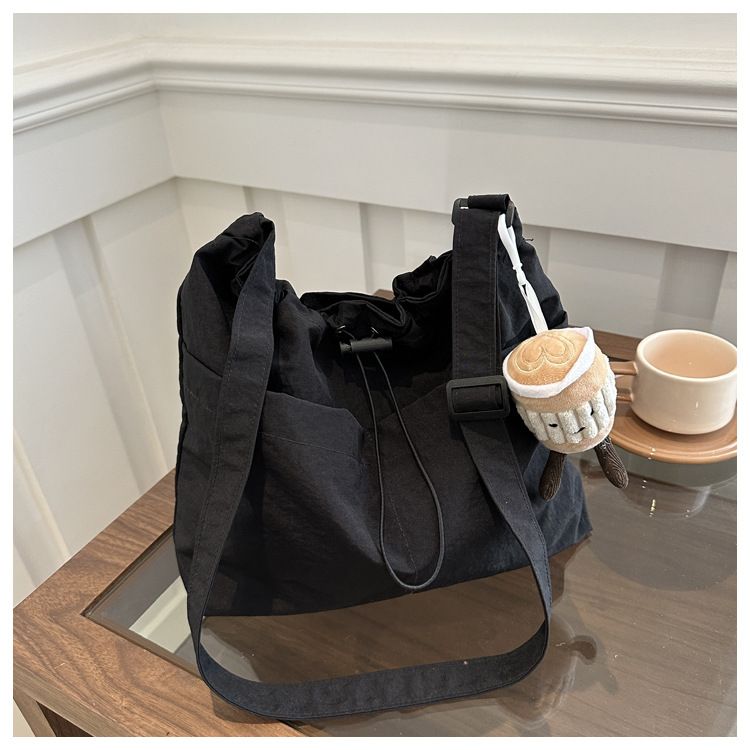 2025 new large capacity waterproof nylon fabric drawstring pleated shoulder bag for travel and leisure, crossbody bucket bag black No accessories