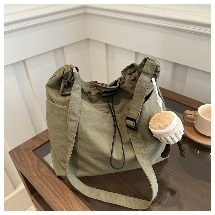 2025 new large capacity waterproof nylon fabric drawstring pleated shoulder bag for travel and leisure, crossbody bucket bag black No accessories