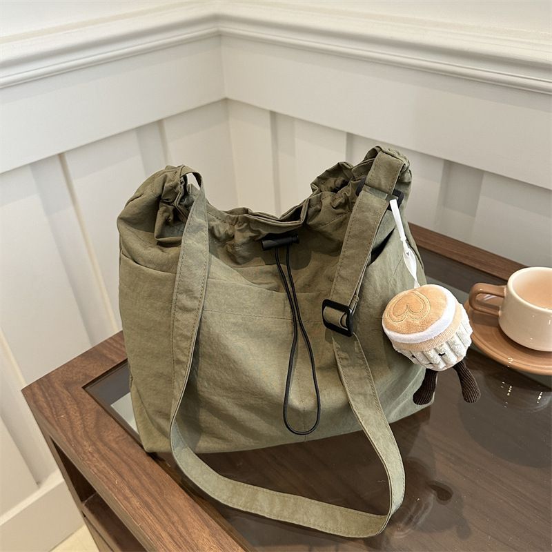 2025 new large capacity waterproof nylon fabric drawstring pleated shoulder bag for travel and leisure, crossbody bucket bag black No accessories