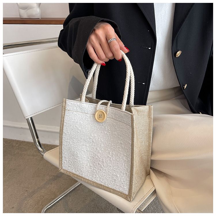 A trendy woman carrying a linen bag to work looks stylish. When she goes out, she carries a lunch bag and a small shoulder bag