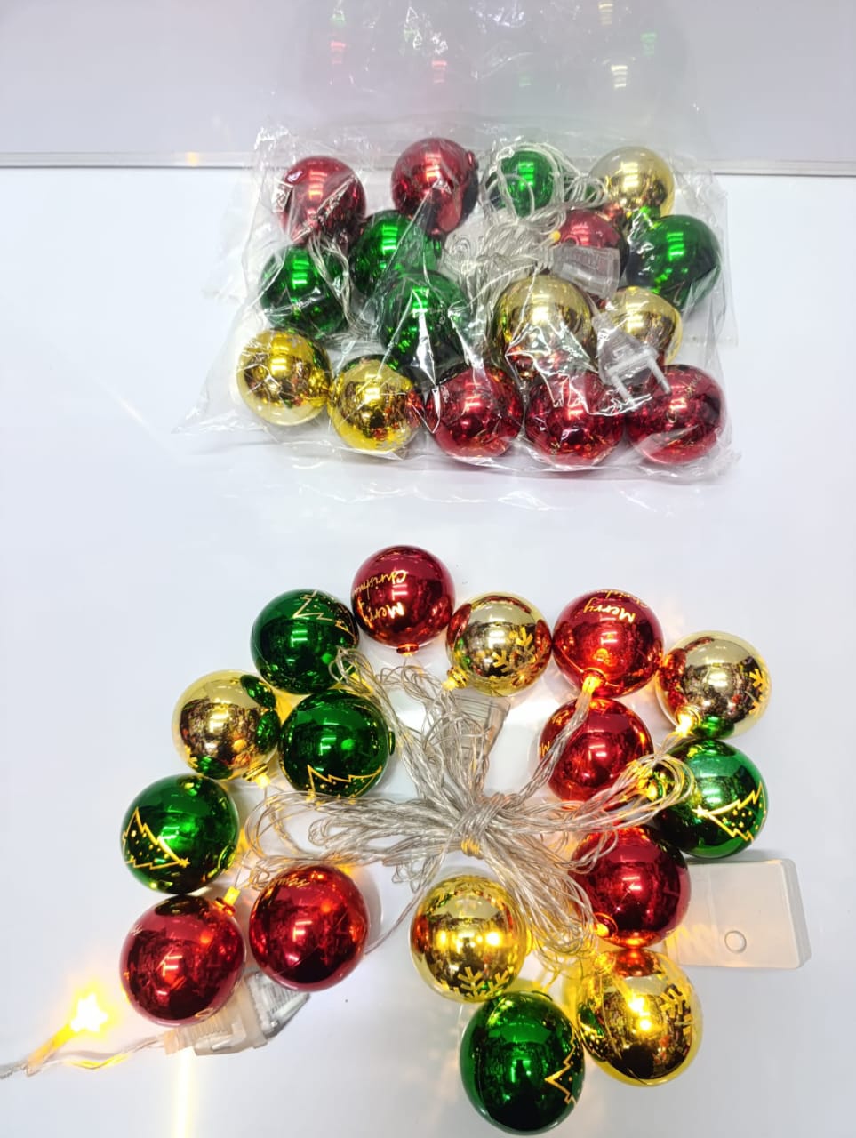 LED Christmas string lights with red, green, and gold ball ornaments. These lights are a common decoration used for the holiday season to add a festive ambiance to indoor and outdoor spaces. 
Design: