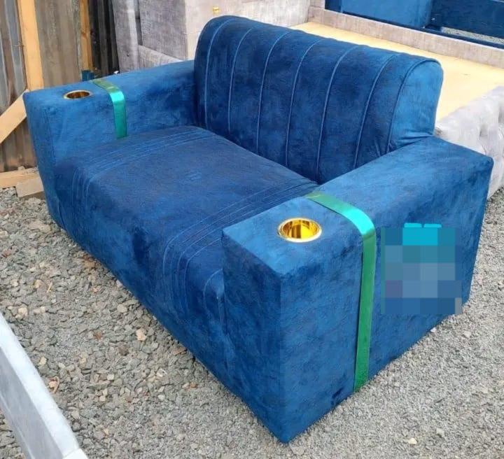 Velvet two-seater sofa with cup holders, potentially