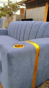 Velvet two-seater sofa with cup holders, potentially