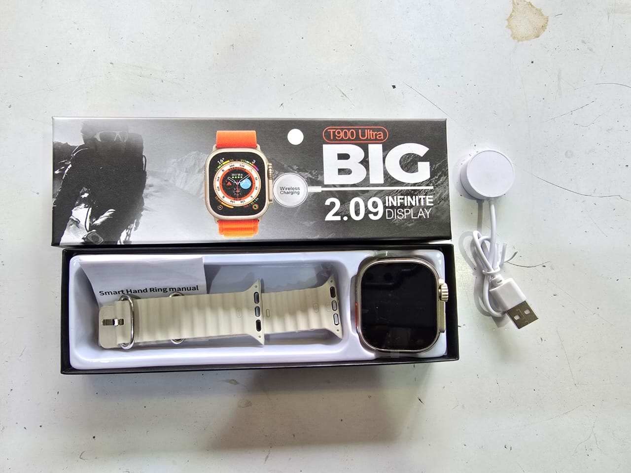 T900 Ultra Smart Watch in its packaging, which is a generic brand smartwatch model known for its large display and fitness tracking features. 
It features a 2.09-inch "infinite" HD display. 
Key funct