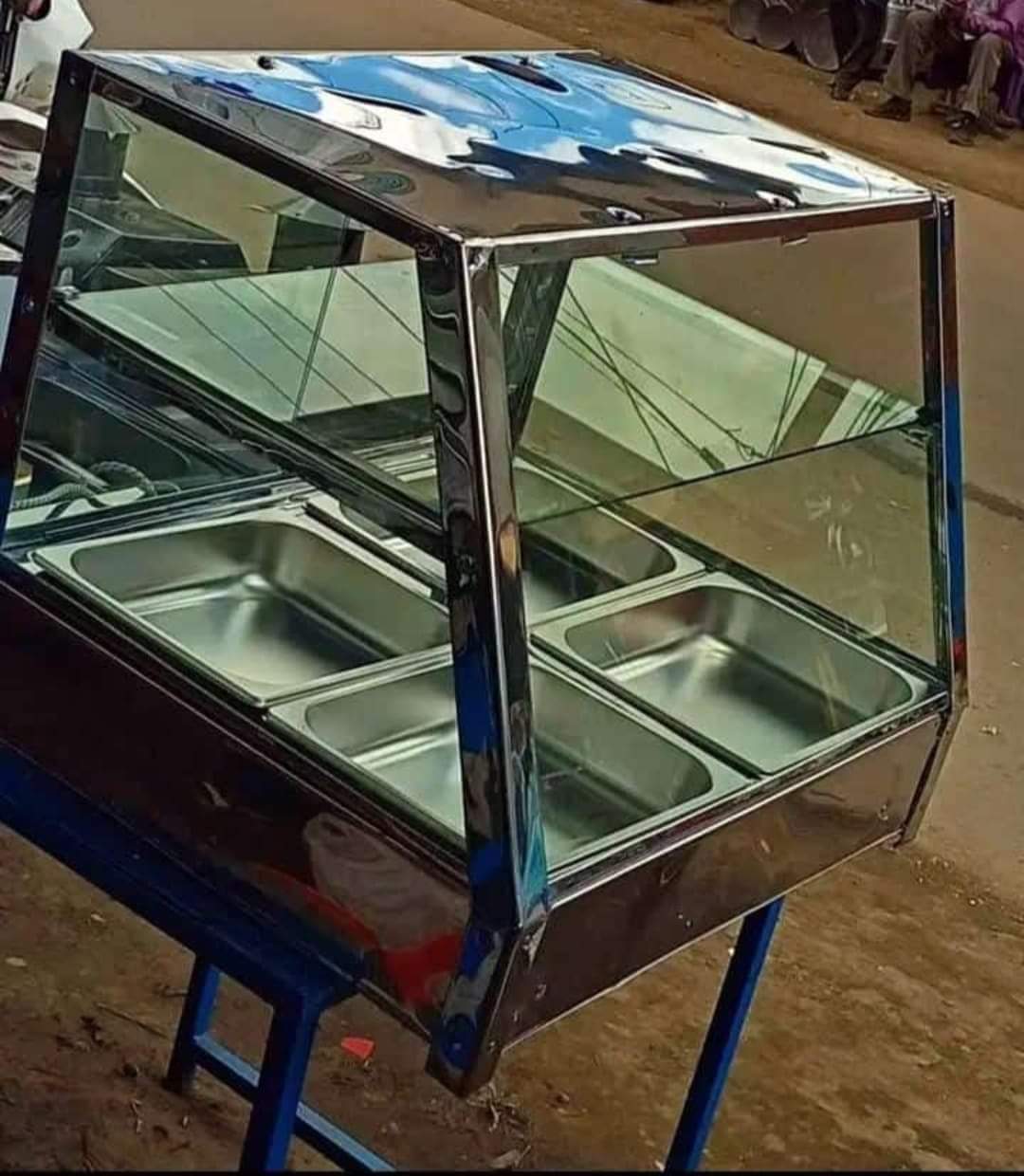 stainless steel commercial food warmer or display counter. 
It is designed to hold pre-cooked foods, such as chips, samosas, and mandazi, at safe serving temperatures for an extended period