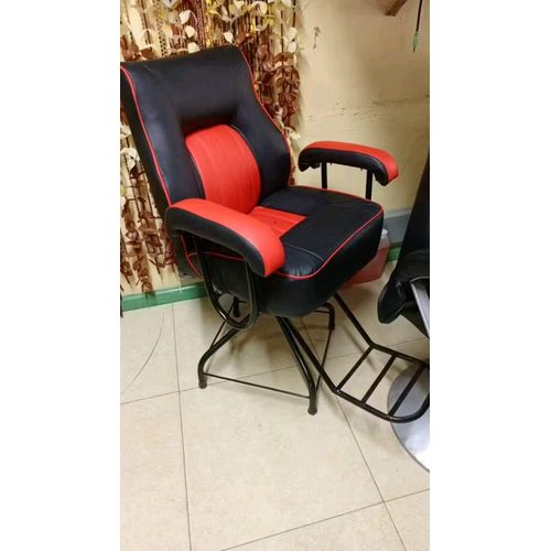 barber chair. These chairs are a common piece of furniture for barbershops and salons, designed for both style and function. 
Design: The chair in the image is black and red with a cushioned seat, bac