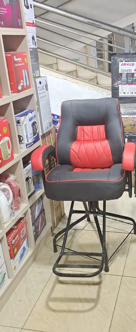 barber chair. These chairs are a common piece of furniture for barbershops and salons, designed for both style and function. 
Design: The chair in the image is black and red with a cushioned seat, bac