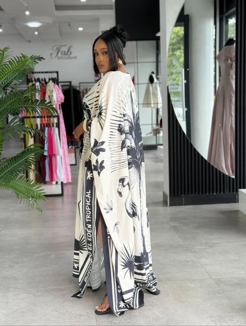 Kaftan dress with a tropical leaf and sunburst design.