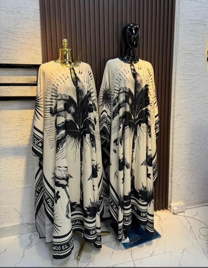 Kaftan dress with a tropical leaf and sunburst design.