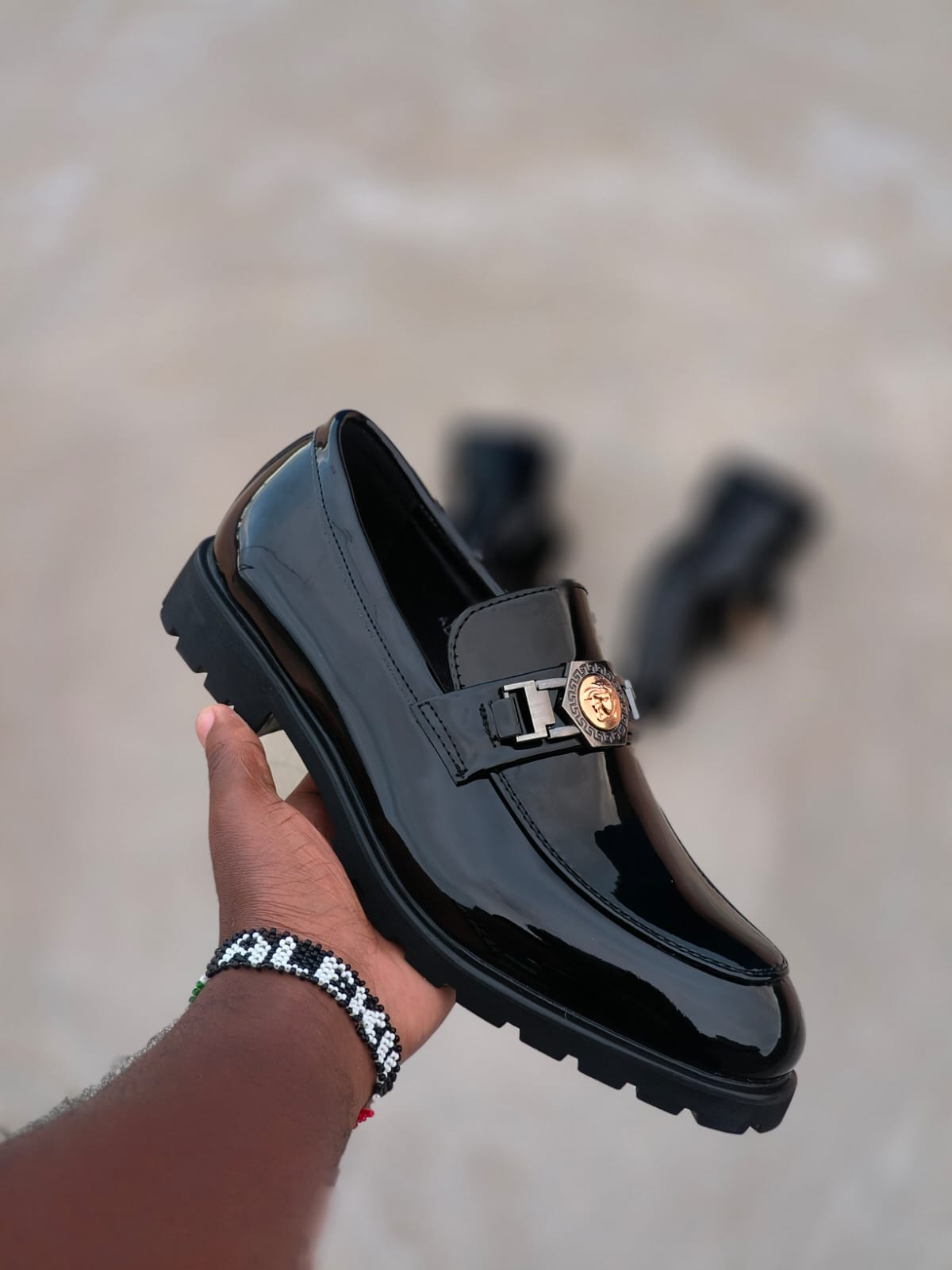 Black Patent Leather Loafers With Chunky Sole Featuring Luxurious Glossy Finish Golden Lion Logo Detail Durable Construction Cushioned Insole Slip-On Design Stylish Comfortable Statement Footwear