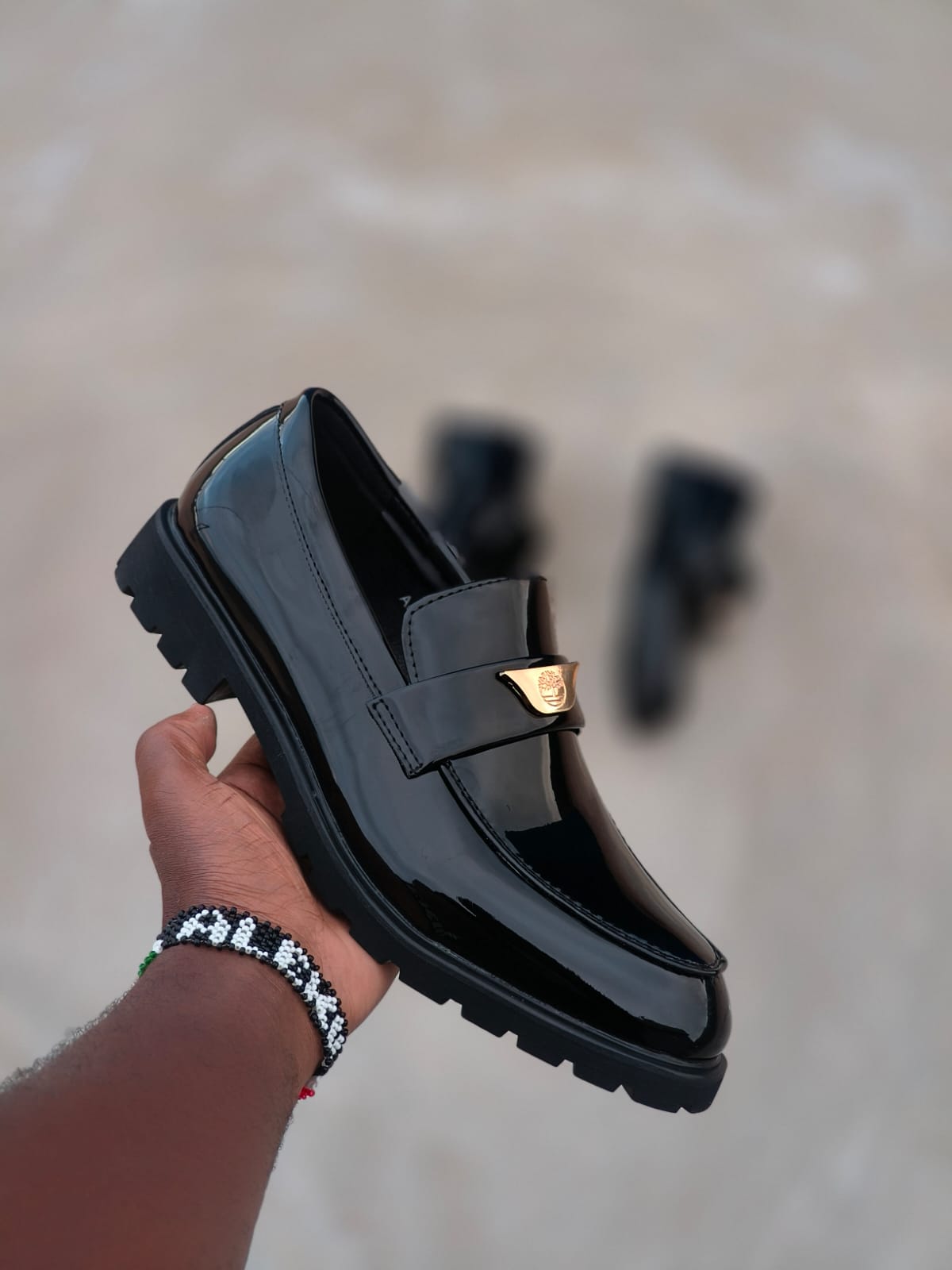 Men’s Black Patent Leather Chunky Sole Loafers With Bold Golden Tone Hardware Glossy Finish Durable Build Cushioned Comfort Slip On Design Luxury Statement Footwear