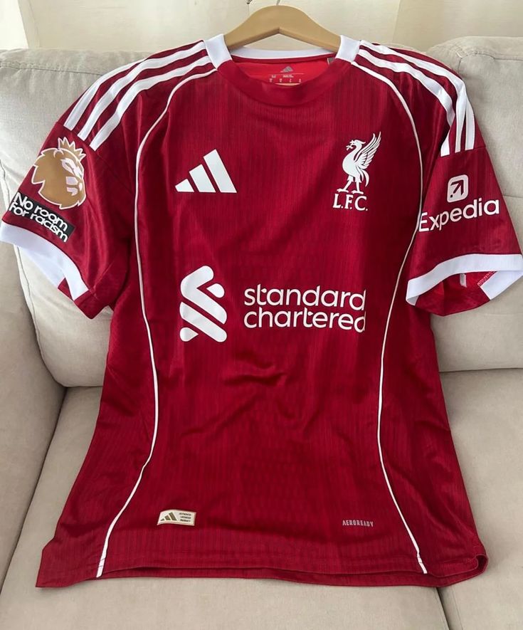 RED Liverpool 25/26 Home jersey.  Maximum Aura Only.Why It’s a Literal Flex:  A deep, rich red that screams authority. It’s the "Home Kit" energy that actually hits different with baggy denim.