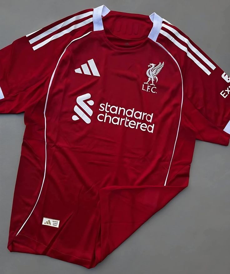RED Liverpool 25/26 Home jersey.  Maximum Aura Only.Why It’s a Literal Flex:  A deep, rich red that screams authority. It’s the "Home Kit" energy that actually hits different with baggy denim.