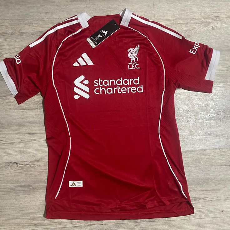 RED Liverpool 25/26 Home jersey.  Maximum Aura Only.Why It’s a Literal Flex:  A deep, rich red that screams authority. It’s the "Home Kit" energy that actually hits different with baggy denim.