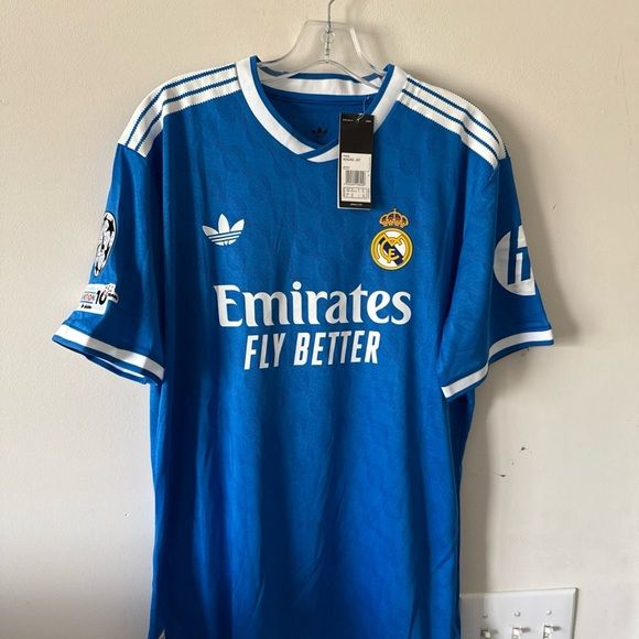 BLUE REAL MADRID 25/26 THIRD KIT. Real Madrid doesn't just play the game; they define it. Whether you’re pairing it with tracks for a workout or denim for a night out, you’re carrying the legacy.