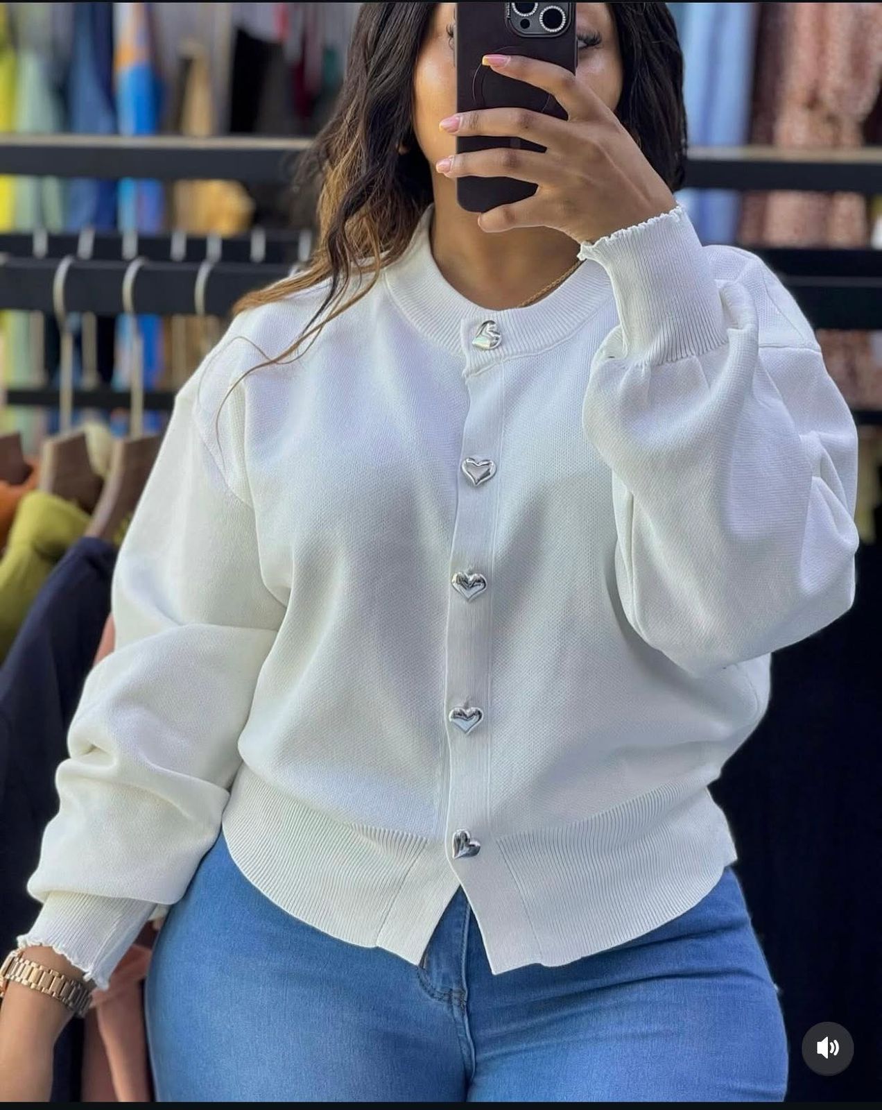 A knitted cardigan or sweater top characterized by its prominent silver/gold-tone heart-shaped buttons and has a slightly cropped length with long, voluminous balloon sleeves that end in ribbed cuffs.