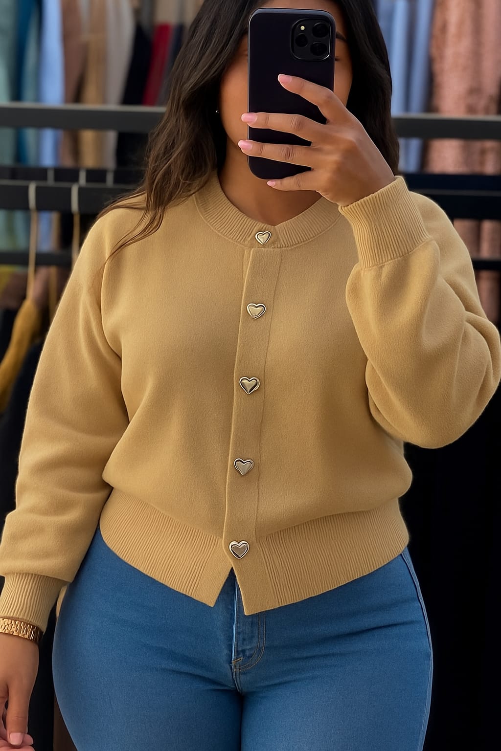 A knitted cardigan or sweater top characterized by its prominent silver/gold-tone heart-shaped buttons and has a slightly cropped length with long, voluminous balloon sleeves that end in ribbed cuffs.