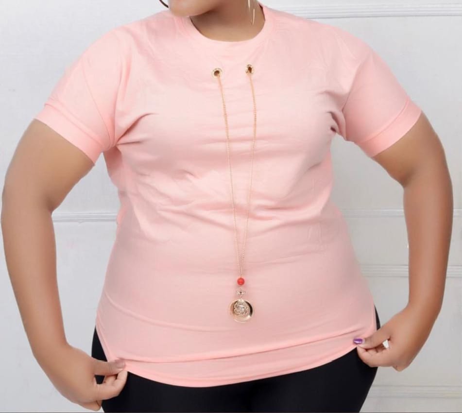 Women Essential Luxe Classic Tee with a long gold-tone necklace with a red bead and circular pendant. Size: Free size