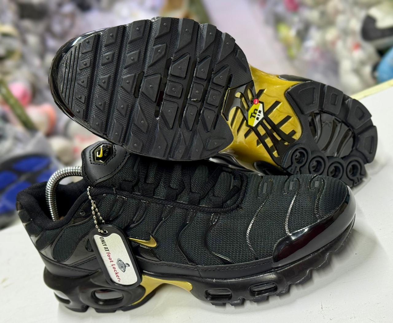 Nike Air Max Plus (TN) — specifically the Black/Gold colorway (often called “Black Metallic Gold TN”).