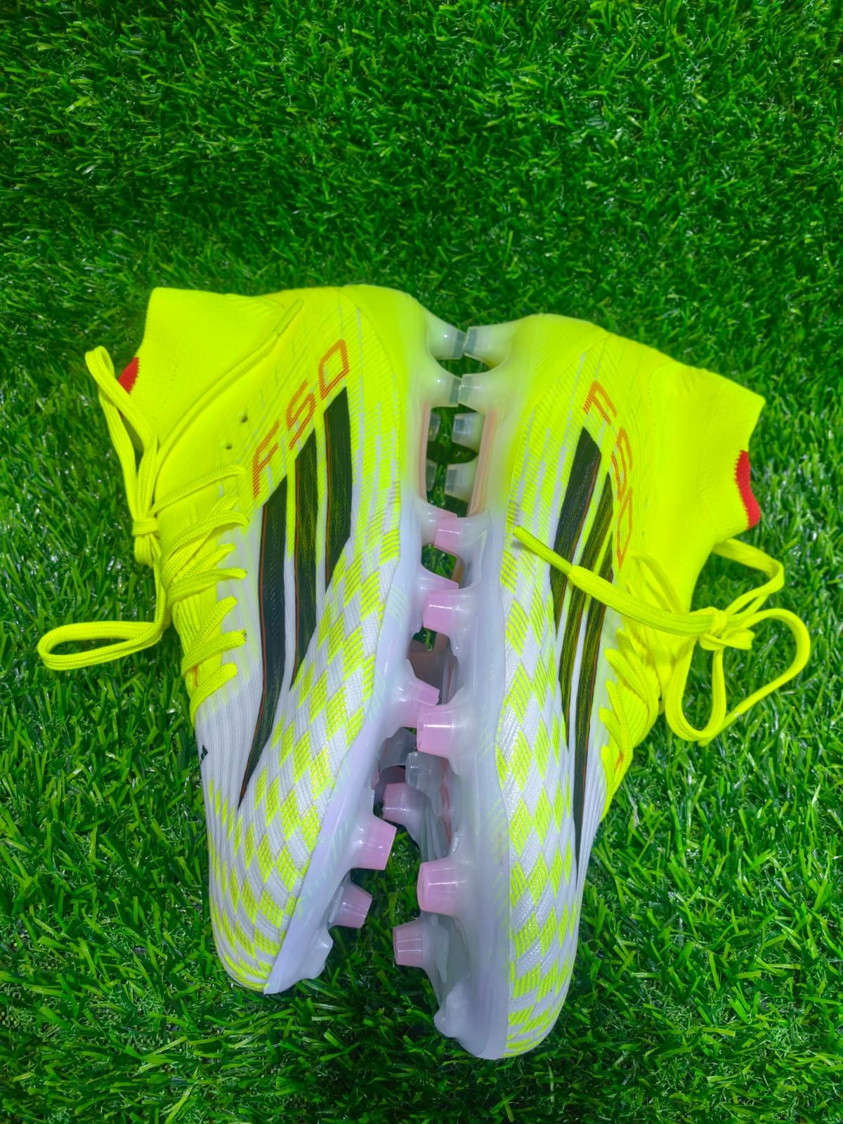 These are Adidas F50 Elite soccer cleats, specifically in the Team Solar Yellow / Core Black / Lucid Red colorway.
