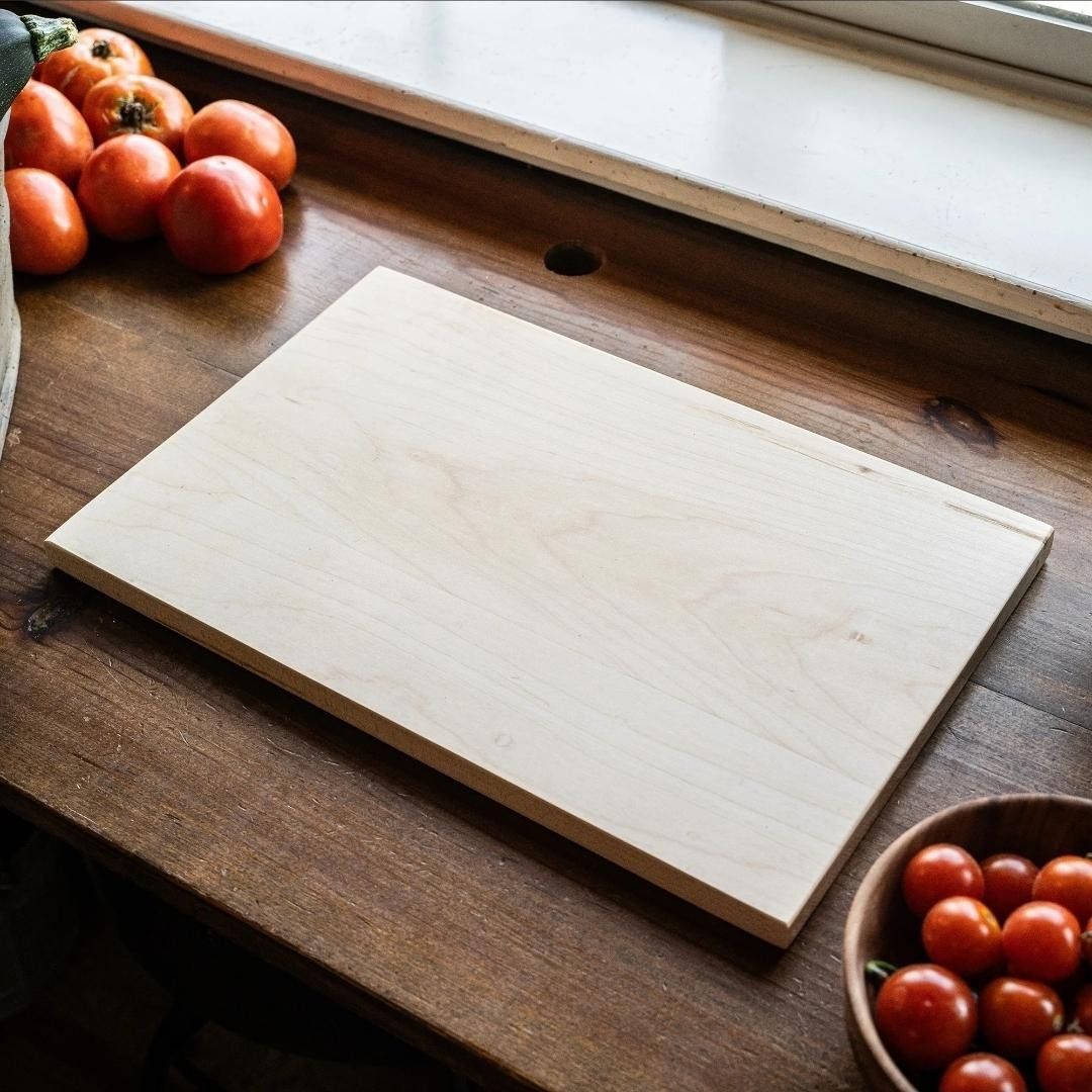 A wood cutting board and a stainless steel knife
