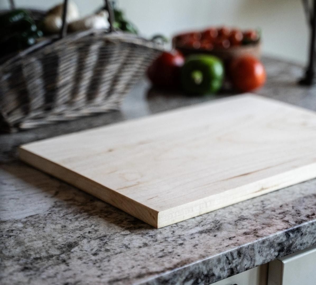 A wood cutting board and a stainless steel knife